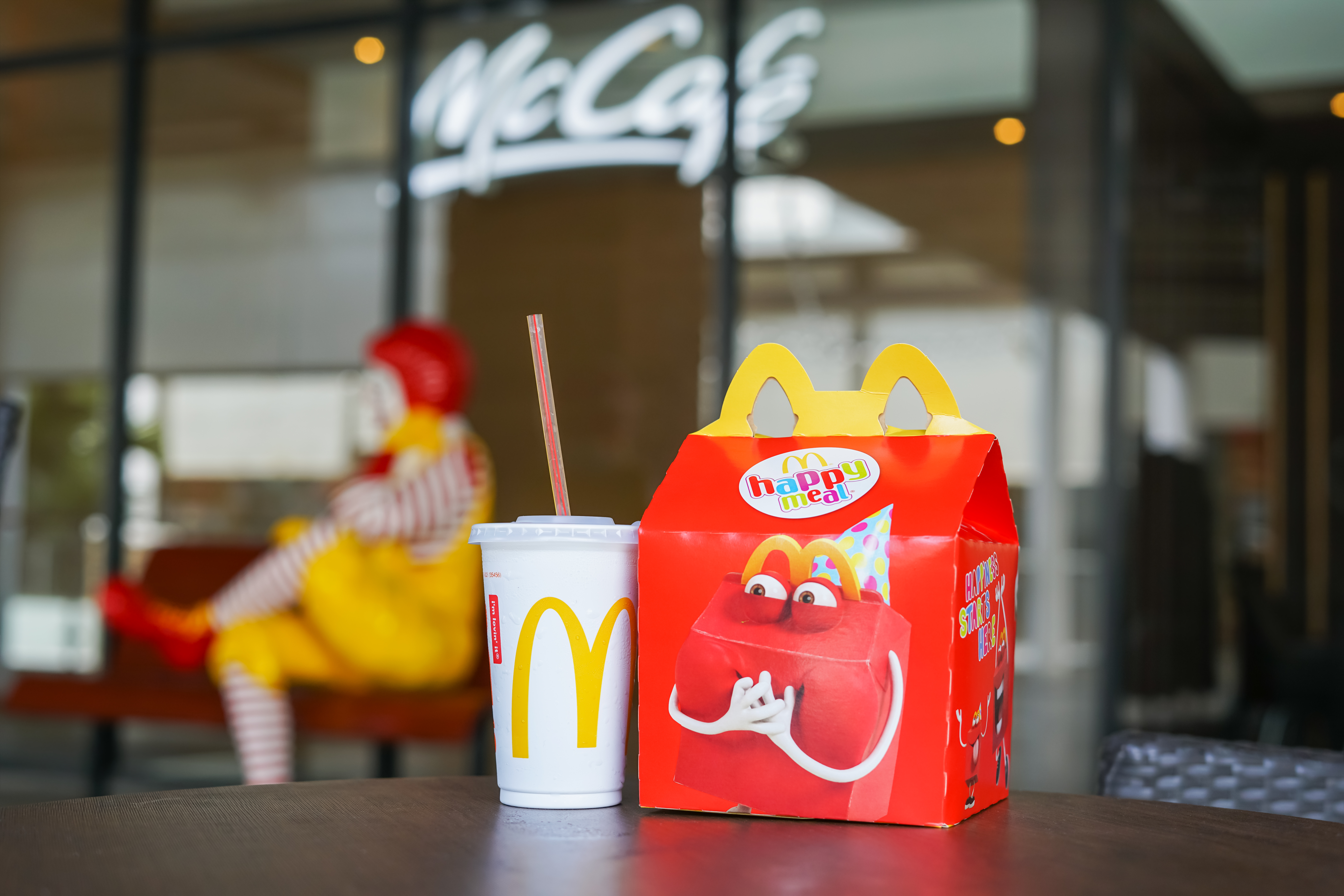 Shutterstock - Ratana21 Bild på "Happy Meal" låda på ett bord med en mugg bredvid