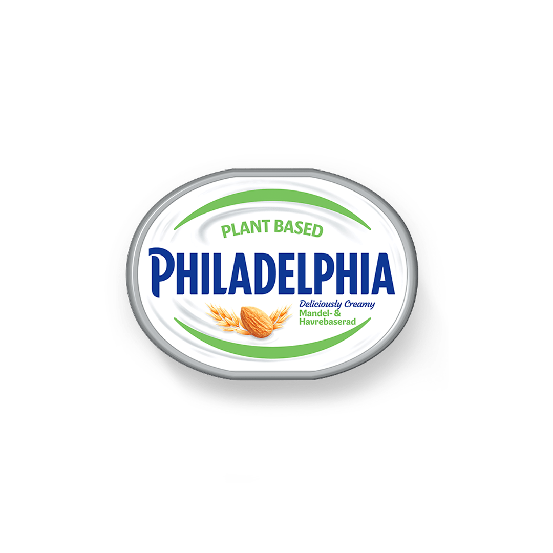 Vegansk färskost i en burk tagen uppifrån mot en vit bakgrund