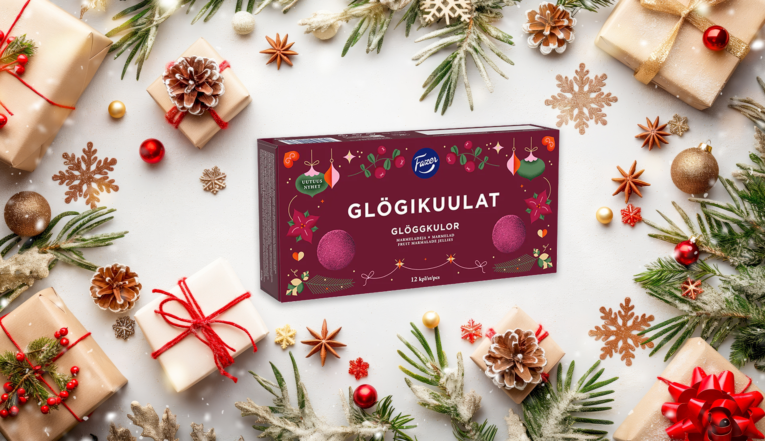 Produktfoto: Fazer En förpackning julgodis mitt i en bild med julpynt runt kanterna