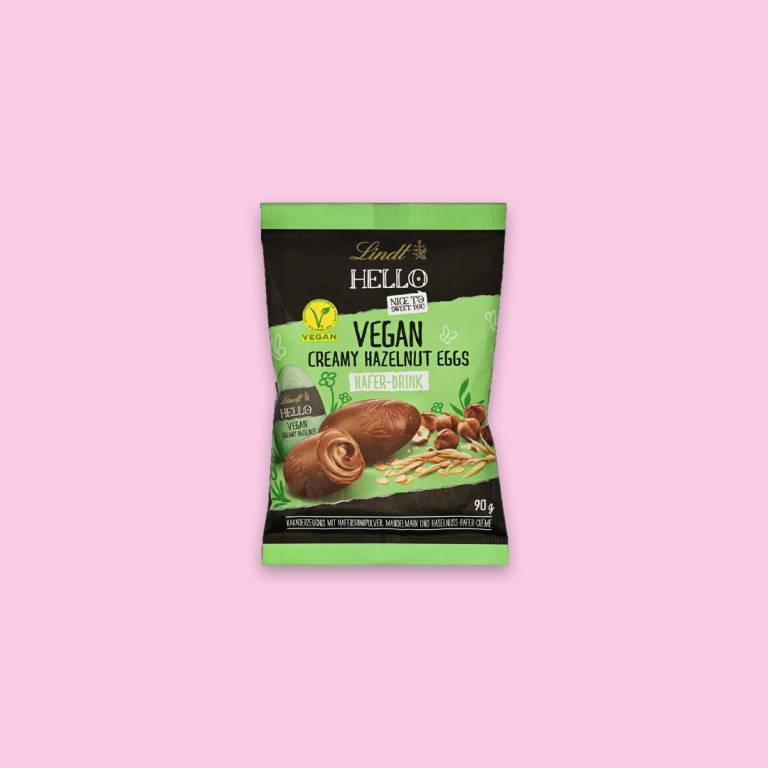 Veganska chokladägg i en påse mot en ljusrosa bakgrund