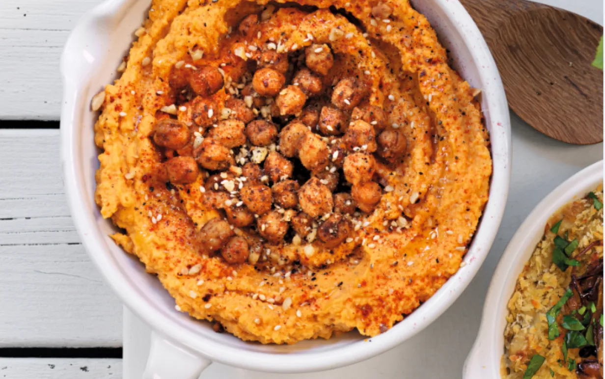 Rostad pumpahummus med rostade kikärter och dukkah i en vit skål