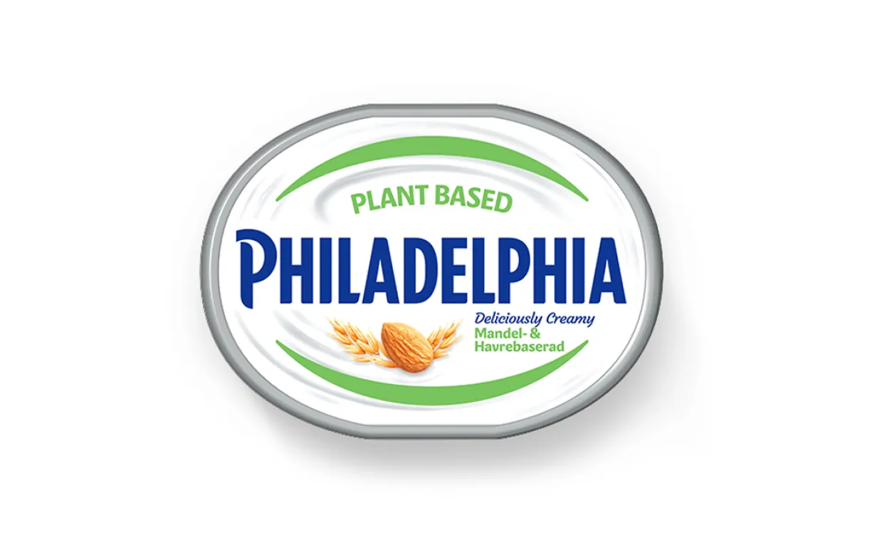 Vegansk färskost i en burk tagen uppifrån mot en vit bakgrund