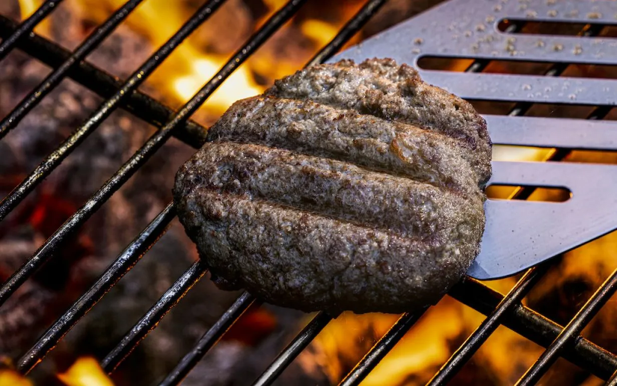 Odlad köttburgare på grillen