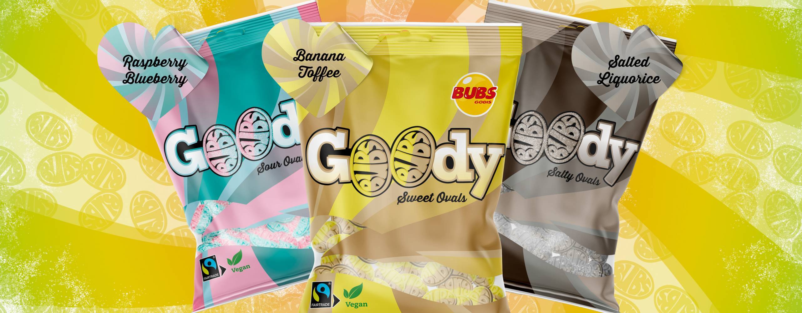 Bild på tre påsar med nya veganska godiset Goody från Bubs Godis. En påse med hallon och lakrits som är blå och rosa, en med banan och toffee som är gul och en med saltlakrits som är svart. Mot en gul bakgrund.