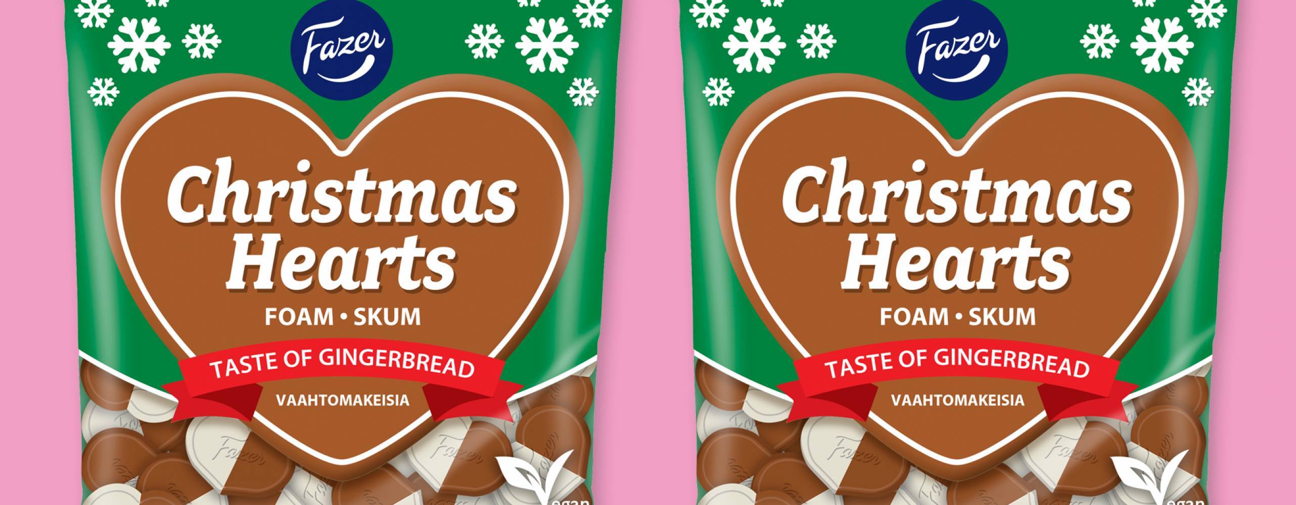 Produktfoto: Fazer Christmas Hearts från Fazer, två påsar bredvid varandra mot rosa bakgrund.