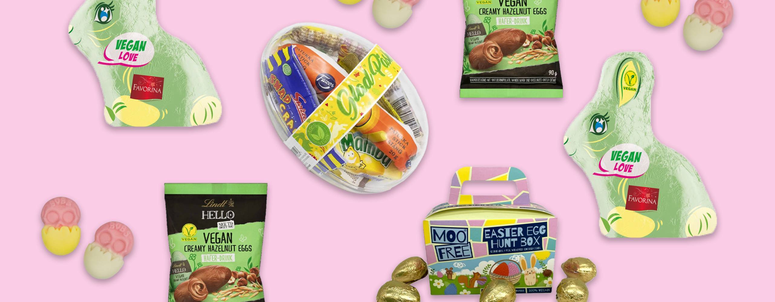 flera veganska påskgodisar utspridda mot en ljusrosa bakgrund