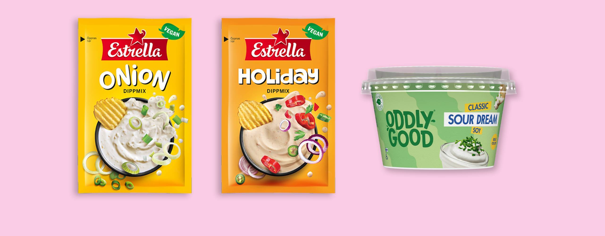 Två påsar dipp och en burk med vegansk fraiche mot en ljusrosa bakgund