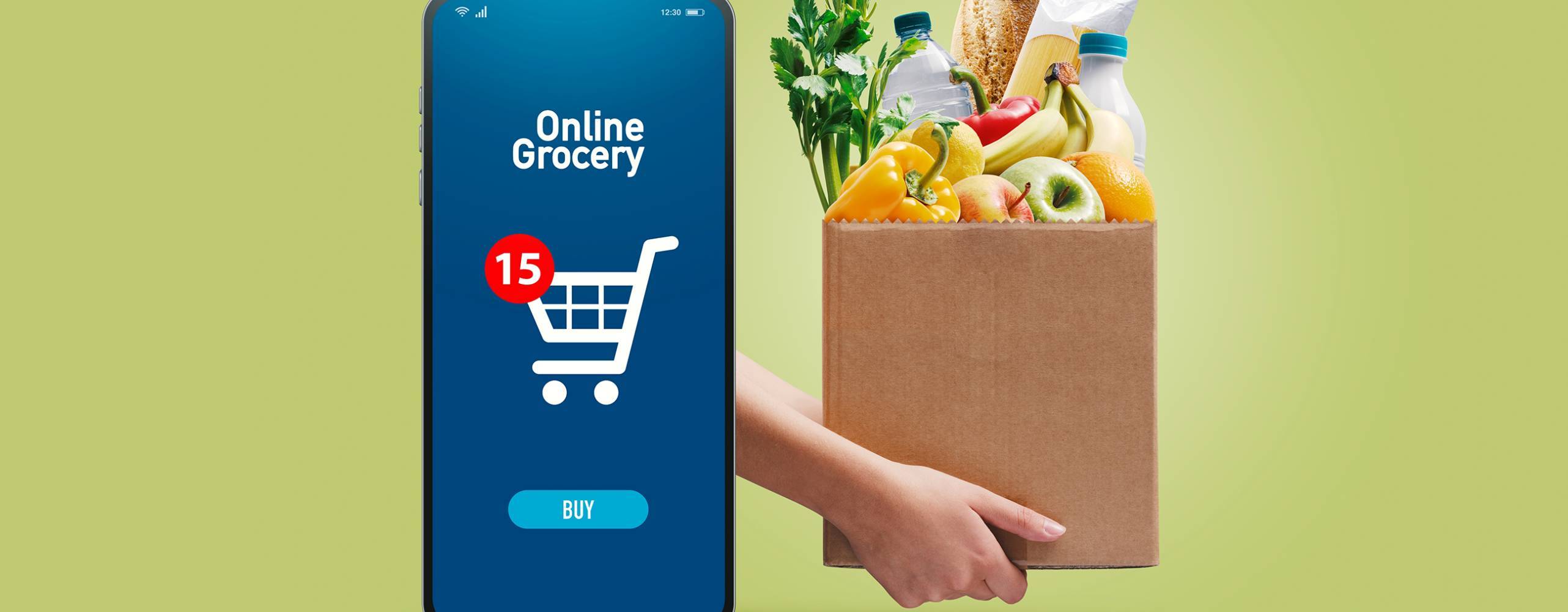 En matkasse med grönsaker och en mobil med en shoppingkorg mot en grön bakgrund