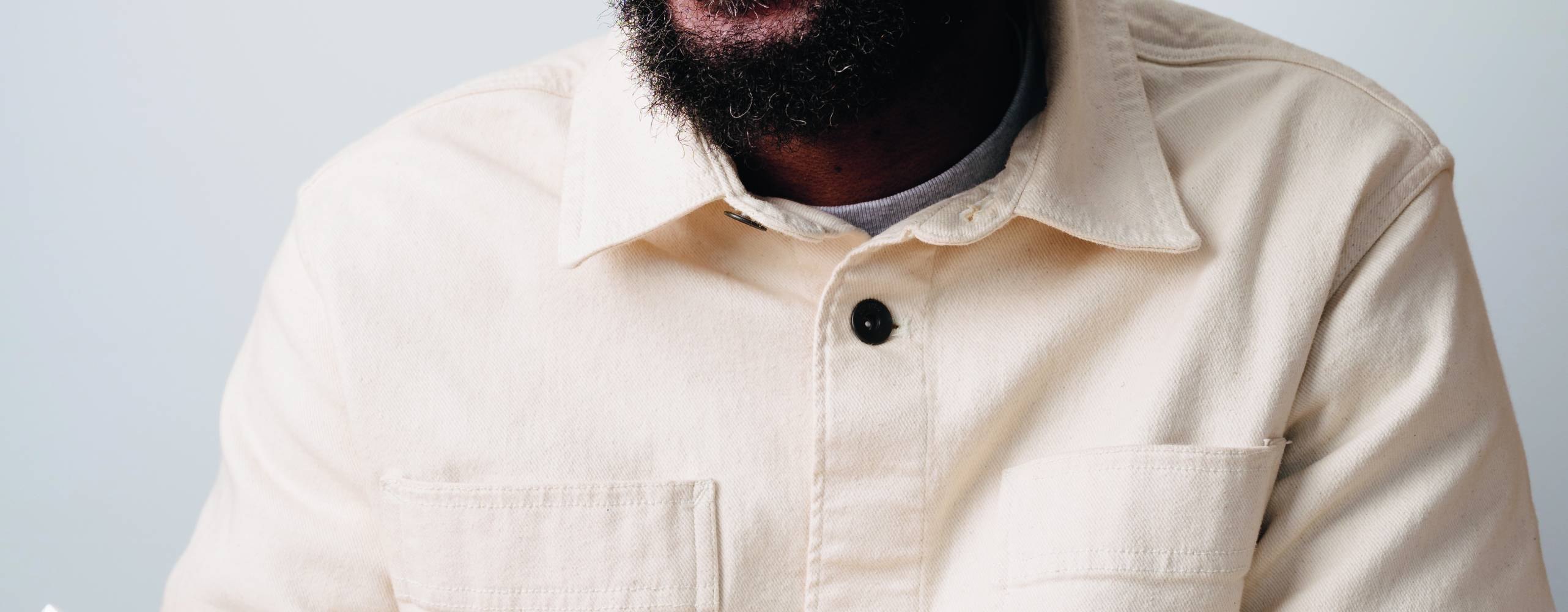 Man med vit skjorta som håller i en djuptallrik med mat